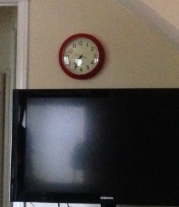 red clock above tv