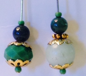 Green faceted bead with bead caps