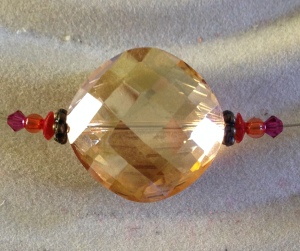 Orange segment with large amber crystal bead